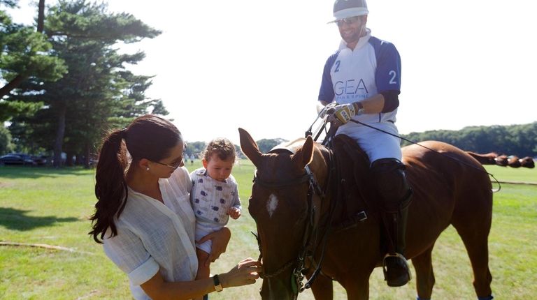 Alexis Lipson, left, and her husband, Adam, introduce his mount...