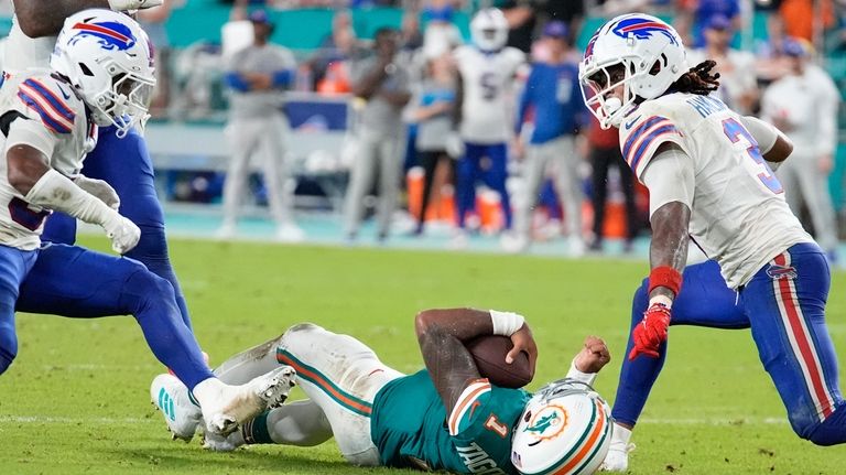 Miami Dolphins quarterback Tua Tagovailoa (1) falls in the field...