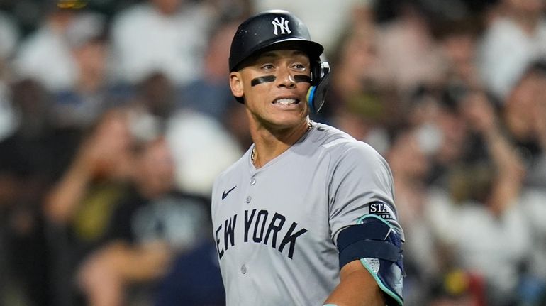 Yankees' Aaron Judge returns to the dugout after being struck...