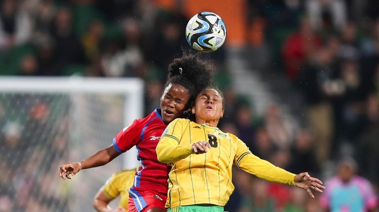 Jamaica's Drew Spence, right, goes for a header with Panama's...