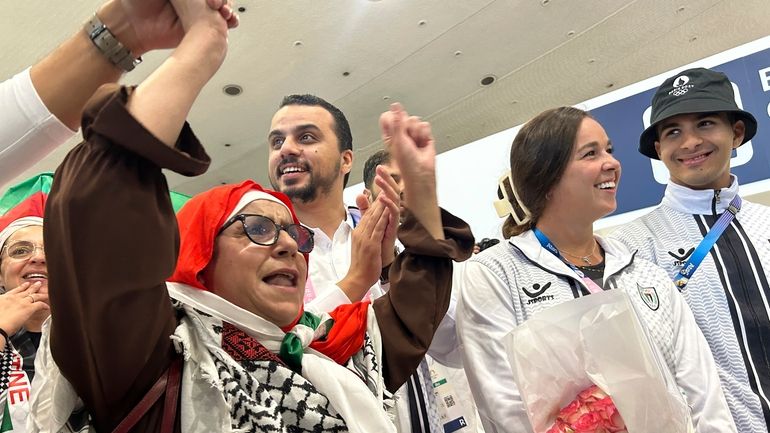 Supporters and fans cheer for Palestinian athletes like Valerie Tarazi,...