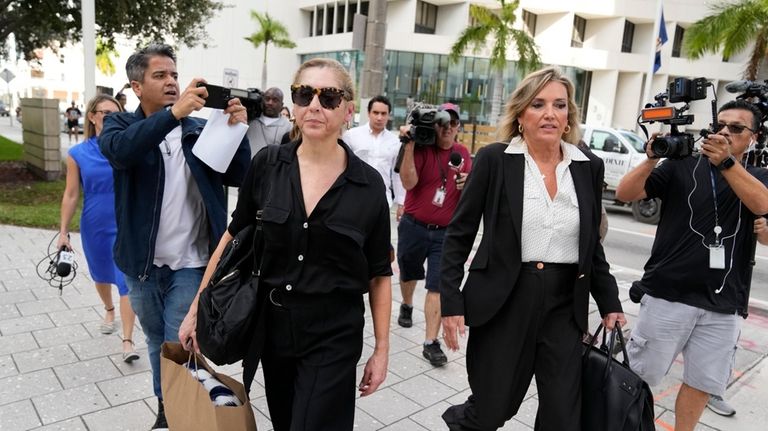 Defense lawyer Jacqueline Arango, center right, and Karla Wittkop Rocha,...