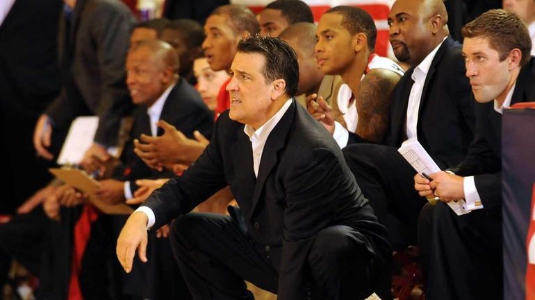 St. John's head coach Steve Lavin, center, leads the Red...