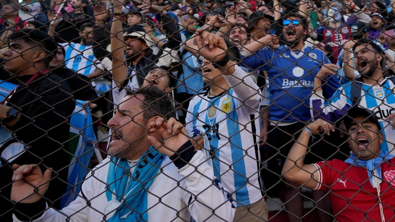 Fans of Argentina cheer during a qualifying soccer match for...