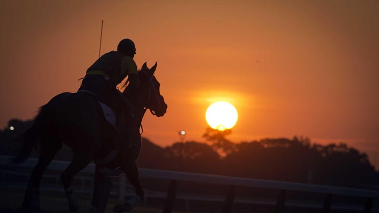 Exercise riders and outriders hitting the track in the early...