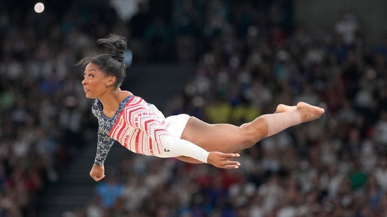 Simone Biles, of the United States, performs on the floor...