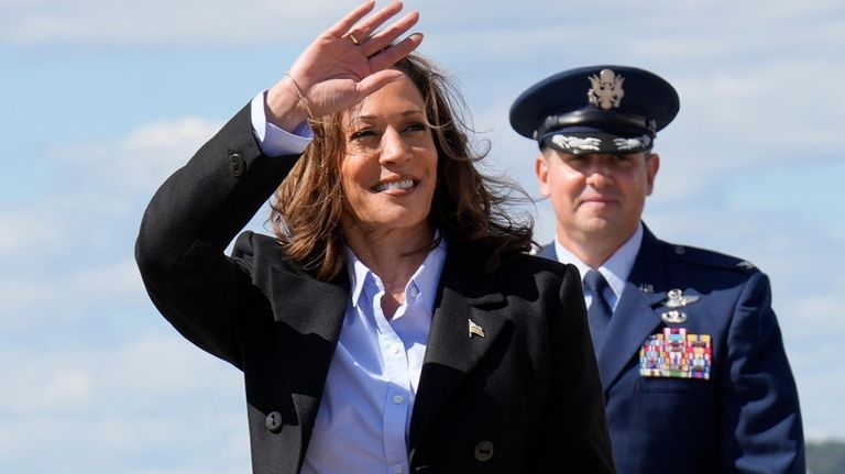 Democratic presidential nominee Vice President Kamala Harris waves as she...