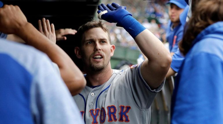 The Mets' Jeff McNeil celebrates with teammates after hitting a...