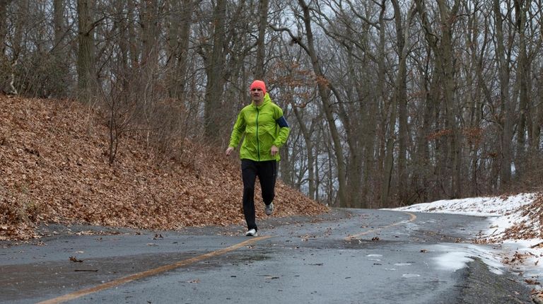 Stefan Judex, of Port Jefferson, runs to his job as...