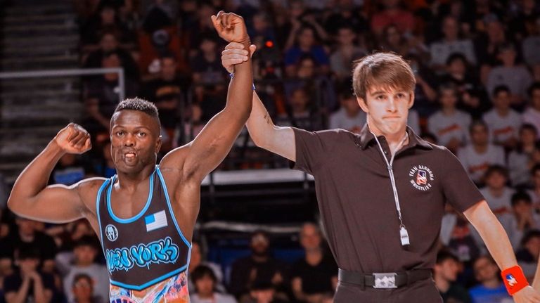 Dunia Sibomana-Rodriguez reacts after winning the 113-pound Junior Men Freestyle...