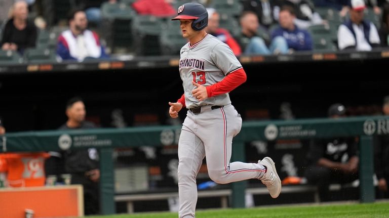 Washington Nationals' Nick Senzel scores on a single from Trey...