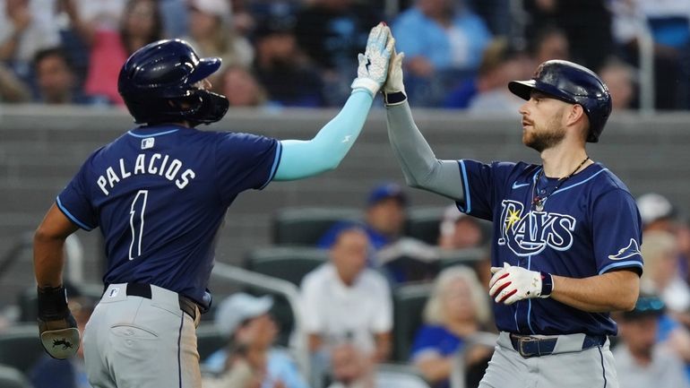 Tampa Bay Rays' Brandon Lowe, right, celebrates his two-run home...