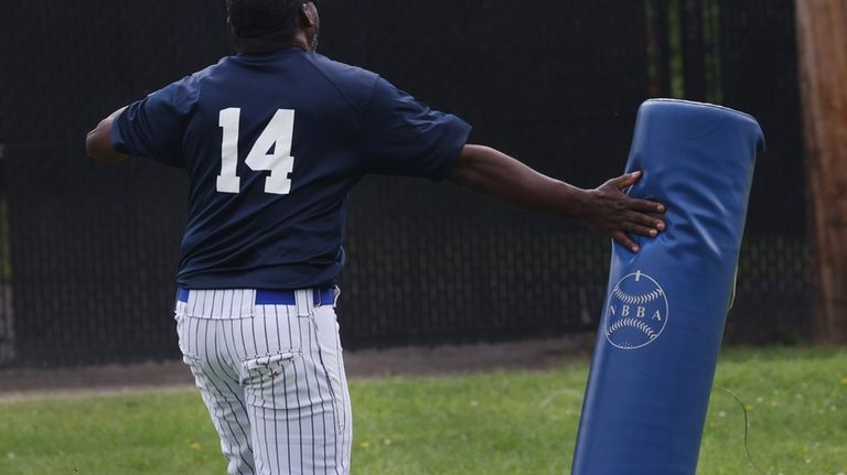 Robert Weeks, of Manhattan, touches first base after hitting the...