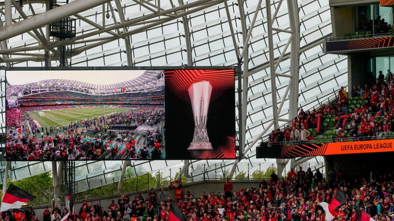 Leverkusen fans wave flags before the Europa League final soccer...