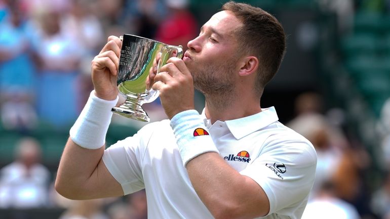 Alfie Hewett of Britain kisses his trophy after defeating Martin...