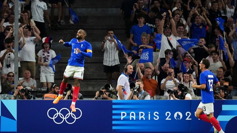 France's Alexandre Lacazette, left, celebrates after scoring his side's first...