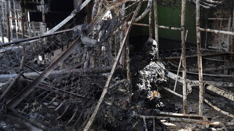 The burned body of a Ukrainian POW lies in the...