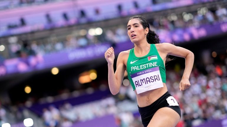 Layla Almasri, of Palestine, competes in a women's 800 meters...