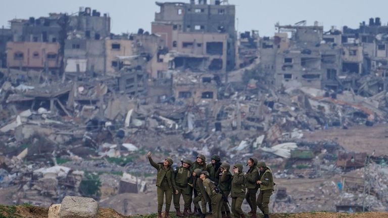 Israeli female soldiers pose for a photo on a position...