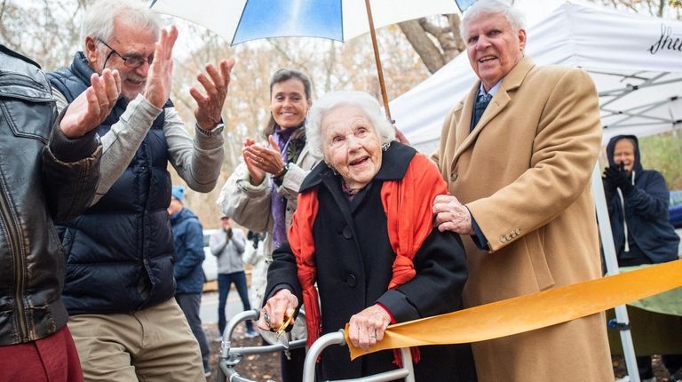 Esther Hird Hunt, center, after cutting the ribbon Friday to...