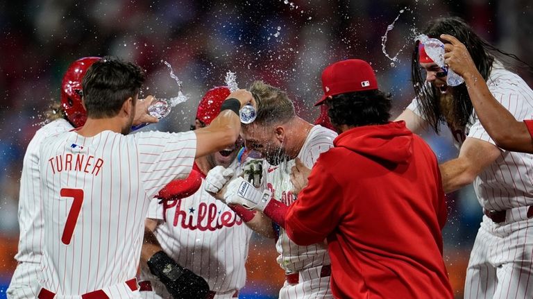 Philadelphia Phillies' Kody Clemens, center, celebrates with teammates after hitting...