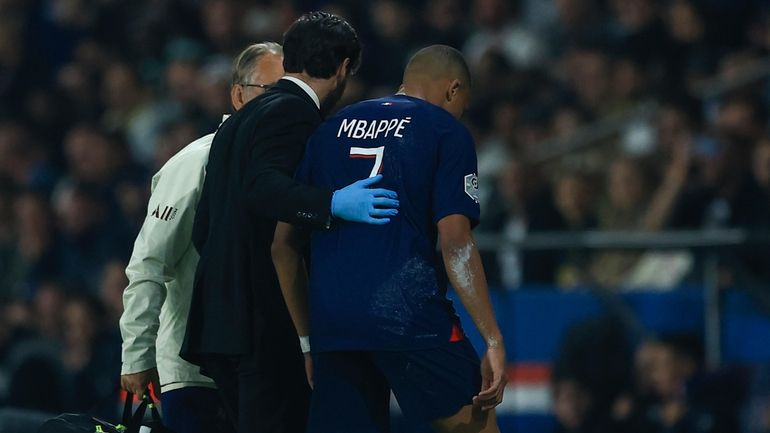 PSG's Kylian Mbappe leaves the pitch with an injury during...