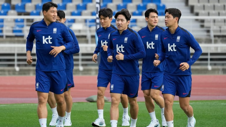 South Korea's Lee Kang-in, center, and teammates warm up during...