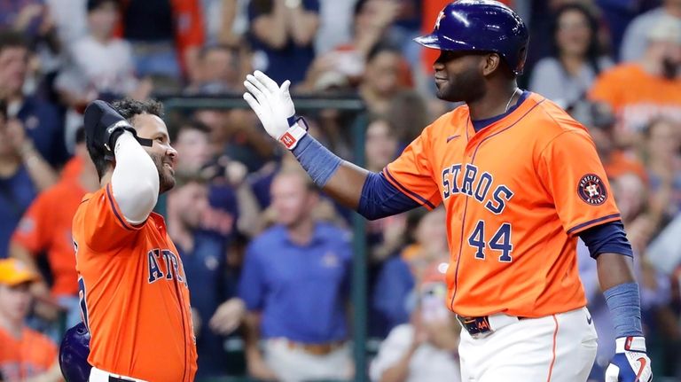 Houston Astros' Jose Altuve, left, and Yordan Alvarez (44) celebrate...