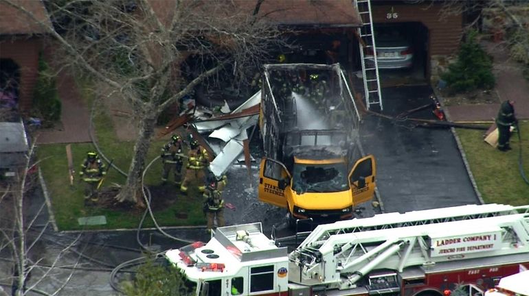 A Stanley Steemer truck caught fire in a Jericho driveway...