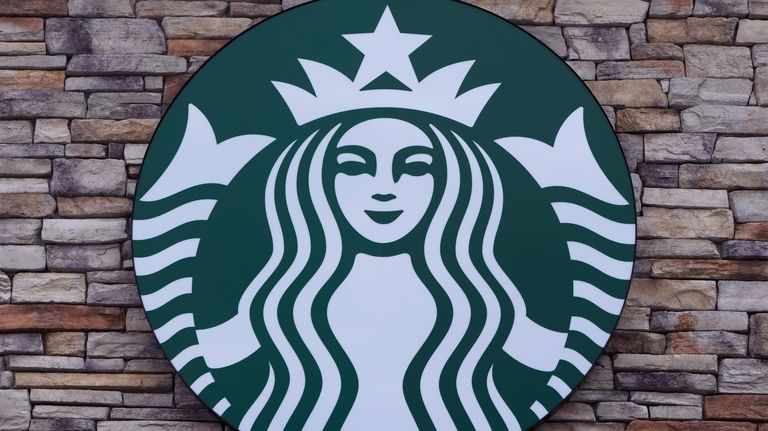 A Starbucks mermaid logo sign is displayed on a store,...