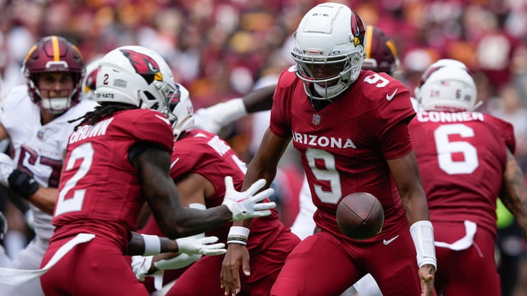 Arizona Cardinals quarterback Joshua Dobbs (9) tosses the ball to...