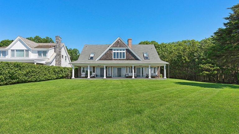 This nearly $6.9 million Mattituck home overlooks Peconic Bay and...