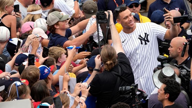 Aaron Judge takes a selfie with a fan's cellphone as...