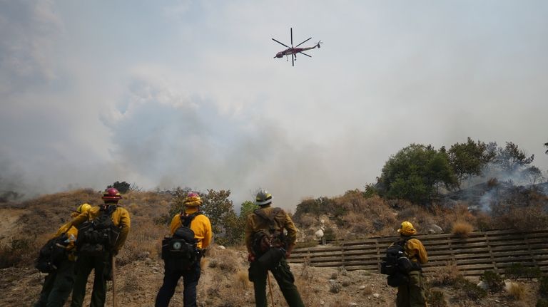 Fire crews monitor the Line Fire Saturday, Sept. 7, 2024,...