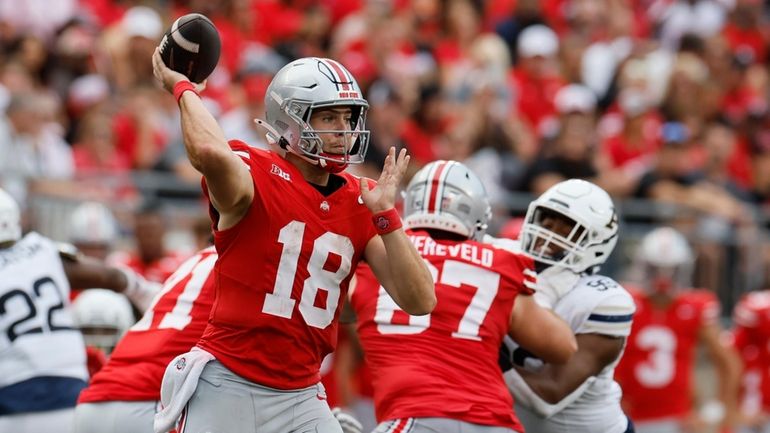 Ohio State quarterback Will Howard (18) looks to throw a...