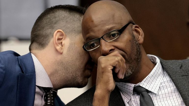 Christopher Dunn, right, listens to his attorney Justin Bonus from...