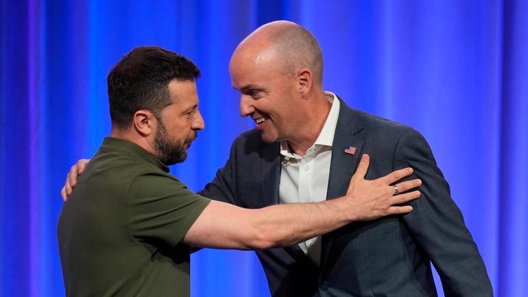 Utah Gov. Spencer Cox, right, greets Ukraine's President Volodymyr Zelenskyy,...