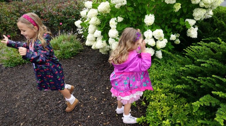 Mazarine Crescenzo, 4, right, and her sister Bianca, 6, release...