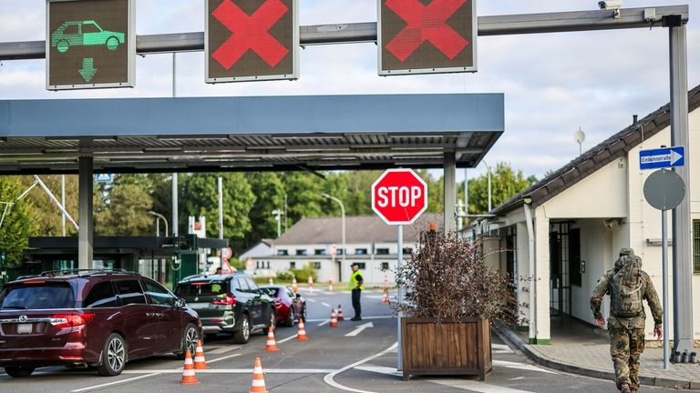 Soldiers check the entrance to the NATO air base, in...