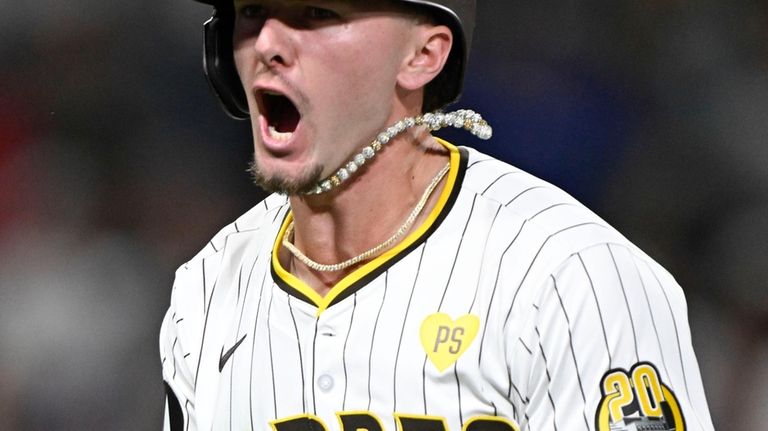 San Diego Padres' Jackson Merrill (3) celebrates after hitting a...