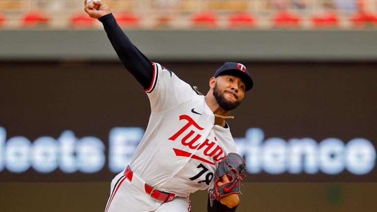 Minnesota Twins starting pitcher Simeon Woods Richardson throws to the...