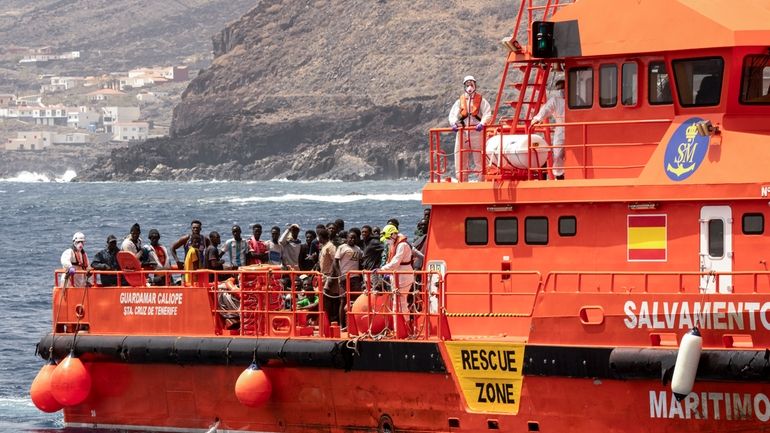 Migrants disembark at the port of on "La Estaca" in...