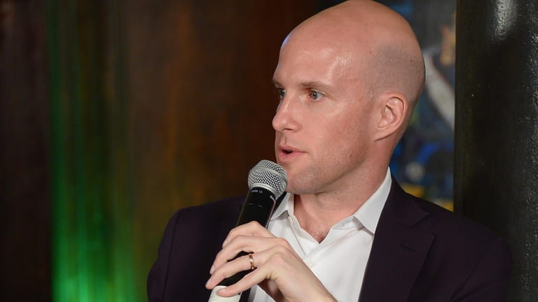 Grant Wahl speaks on a panel discussion at the 2014...