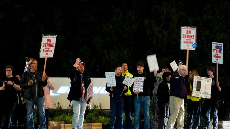 Boeing workers picket after union members voted overwhelmingly to reject...