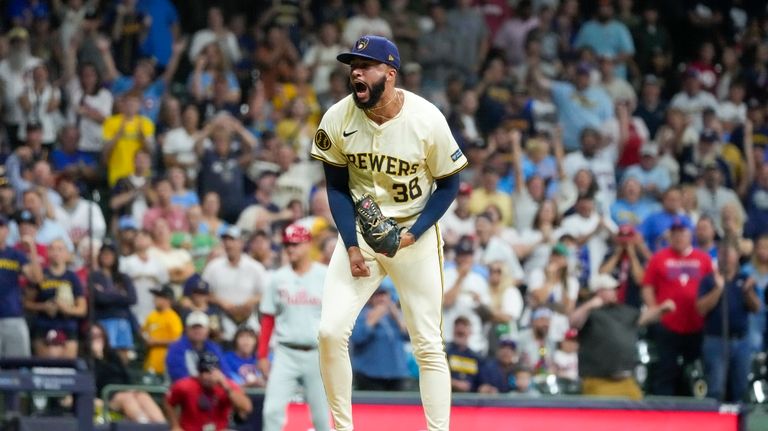 Milwaukee Brewers pitcher Devin Williams reacts after striking out Philadelphia...