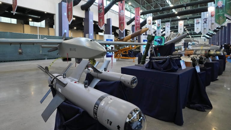 Iran's domestically built drones and weapons are displayed in an...