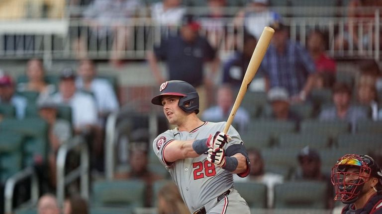 Washington Nationals' Lane Thomas (28) hits a double the third...