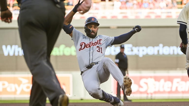 Detroit Tigers' Riley Greene slides into third base on a...
