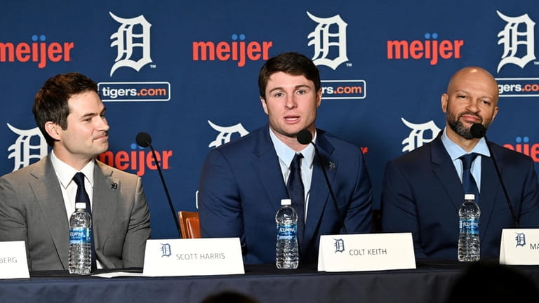 Detroit Tigers president of baseball operations Scott Harris, left, listens...