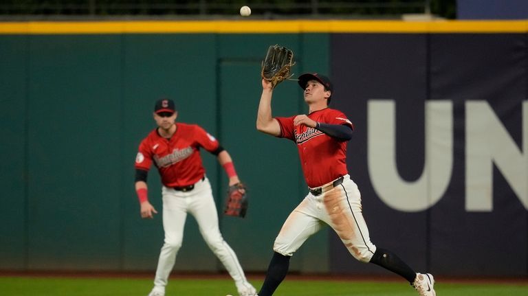 Cleveland Guardians right fielder Will Brennan catches a fly ball...